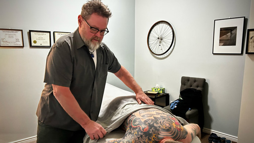 Walter Dawes, professional massage therapist, with a client in his studio